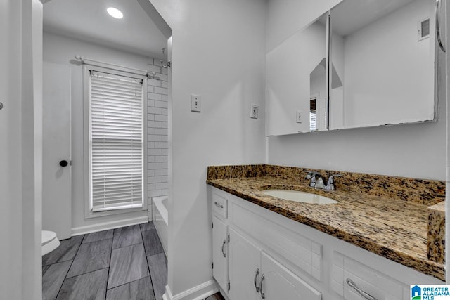 bathroom featuring vanity and toilet