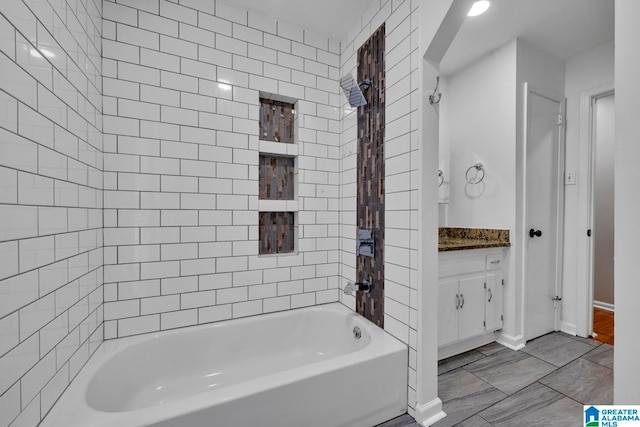 bathroom featuring vanity and tiled shower / bath