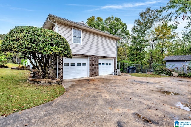 view of home's exterior with a yard and a garage