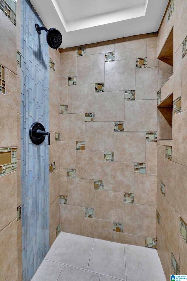 bathroom featuring tiled shower, tile patterned floors, and a raised ceiling