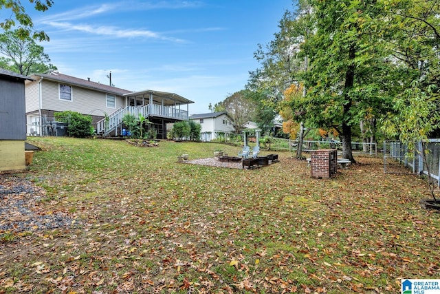 view of yard with a fire pit and a wooden deck