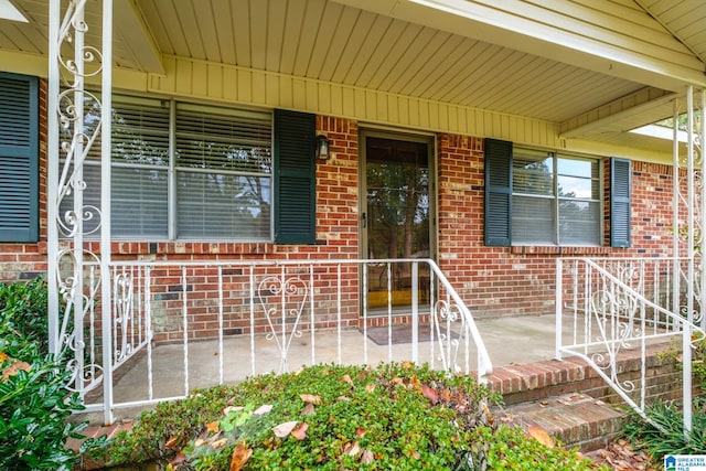 doorway to property with a patio and a porch