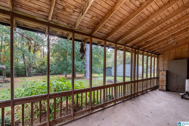 unfurnished sunroom featuring vaulted ceiling