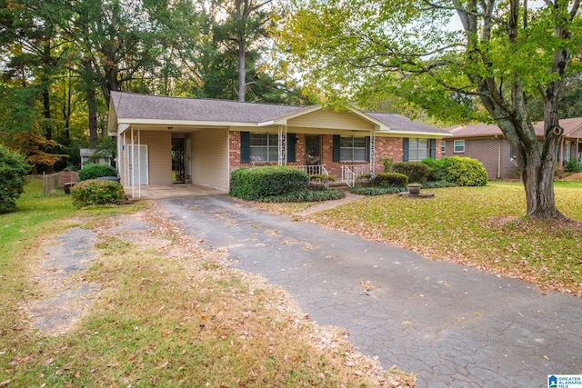 ranch-style home with a porch and a carport