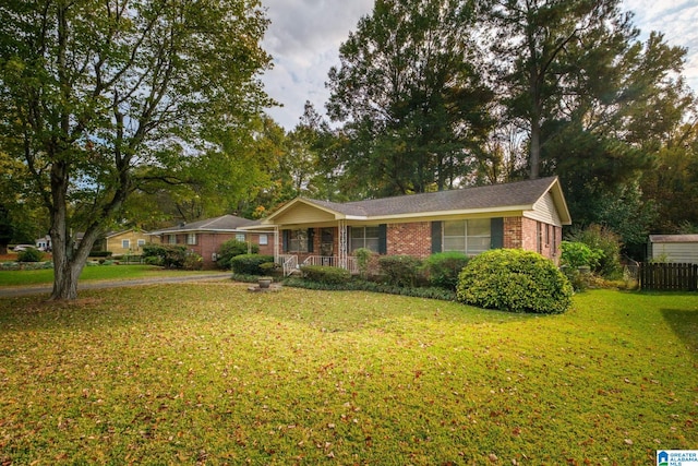 ranch-style home with a front lawn and covered porch