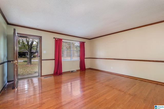 unfurnished room featuring light hardwood / wood-style floors, crown molding, and a textured ceiling