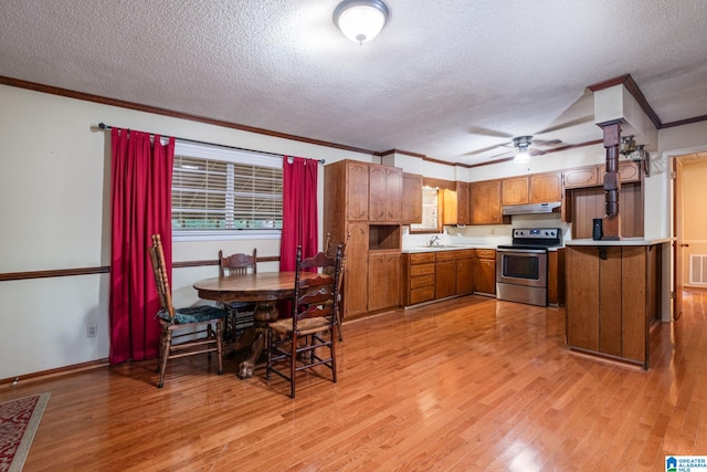 kitchen featuring sink, stainless steel electric stove, a textured ceiling, and light wood-type flooring