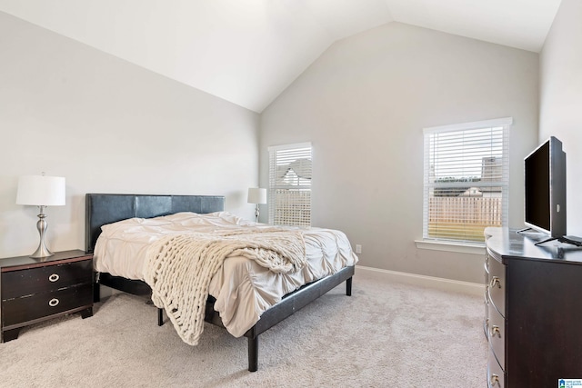 bedroom with lofted ceiling and light carpet