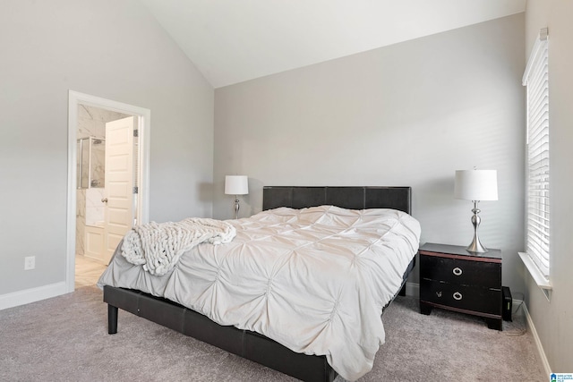 bedroom featuring light carpet, connected bathroom, and vaulted ceiling