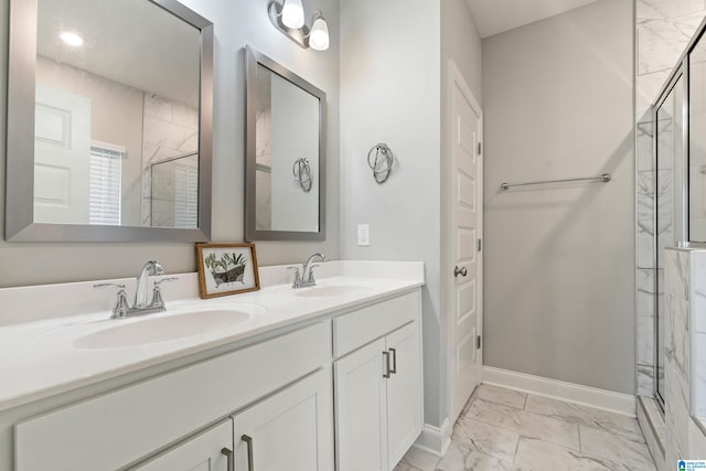 bathroom featuring a shower with door and vanity