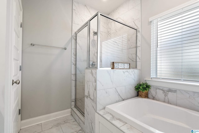 569 Avondale Ln, Pell City, AL 35128 - bathroom with a stall shower, a garden tub, marble look tile flooring, and baseboards