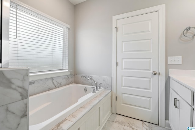 bathroom with vanity and a washtub