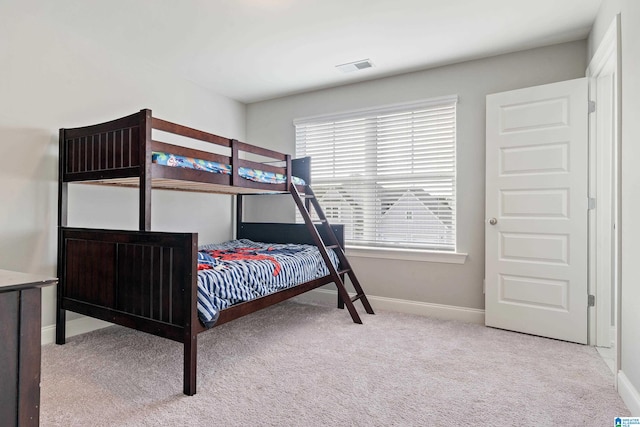 bedroom featuring light carpet