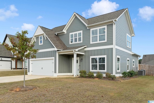 view of front of house with central air condition unit, a front yard, and a garage