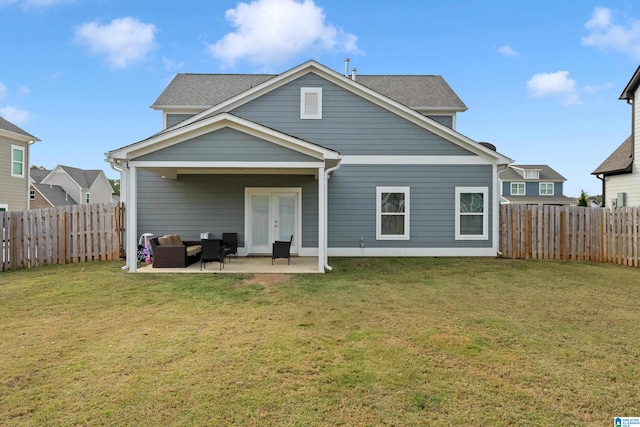 back of house featuring a patio and a lawn