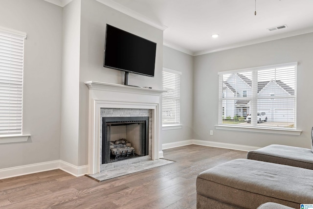 569 Avondale Ln, Pell City, AL 35128 - living room with a fireplace with flush hearth, wood finished floors, baseboards, and crown molding