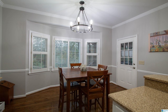 dining space featuring dark wood-type flooring, an inviting chandelier, and ornamental molding