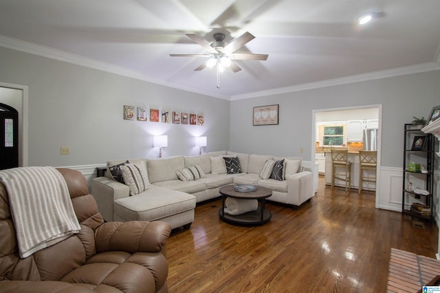 living room featuring dark hardwood / wood-style floors, crown molding, and ceiling fan