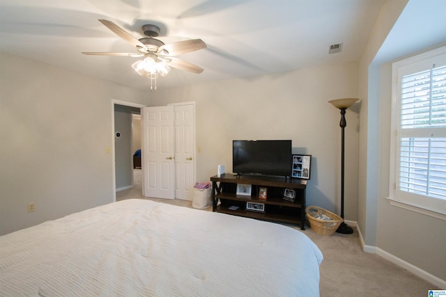 bedroom with light carpet and ceiling fan