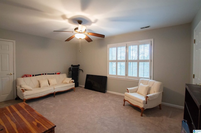 living area with light colored carpet and ceiling fan