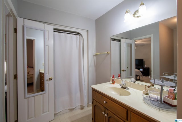 bathroom featuring a shower with curtain, vanity, and tile patterned floors