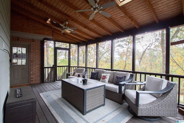 sunroom / solarium with vaulted ceiling with beams, ceiling fan, and wood ceiling