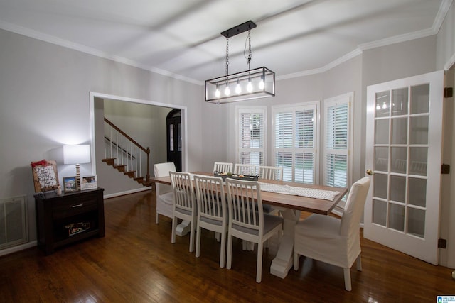 dining space featuring ornamental molding and dark hardwood / wood-style floors