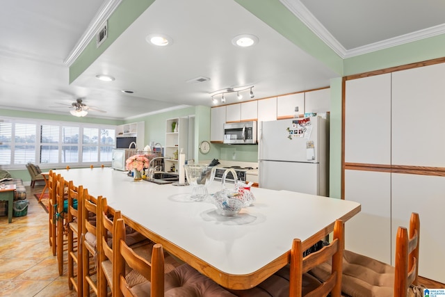 kitchen featuring crown molding, light tile patterned floors, white cabinets, white appliances, and ceiling fan