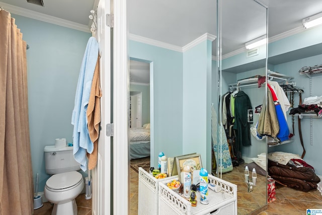 bathroom featuring crown molding, tile patterned flooring, and toilet