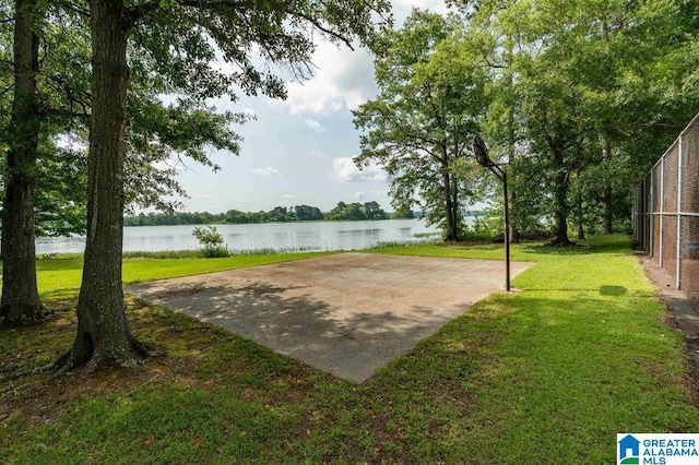 view of community with a lawn and a water view