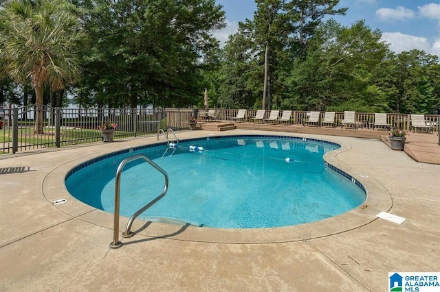 view of swimming pool with a patio area