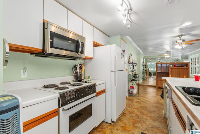 kitchen featuring crown molding, sink, white cabinets, white appliances, and ceiling fan