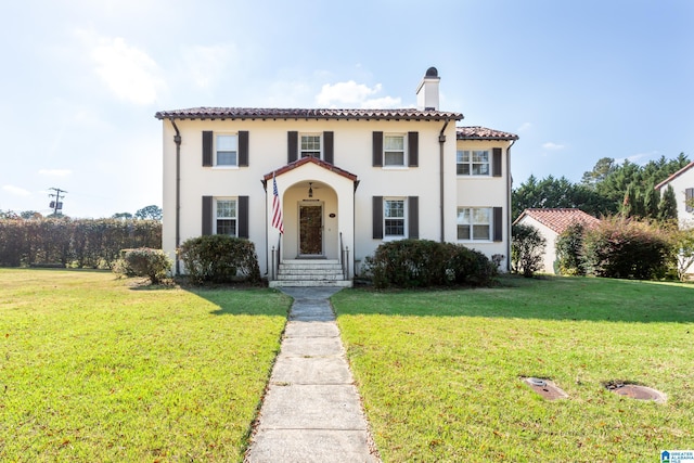 mediterranean / spanish house featuring a front lawn