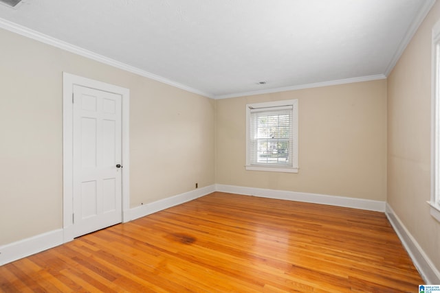 unfurnished room featuring crown molding and hardwood / wood-style floors