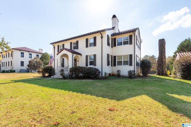 mediterranean / spanish house featuring a front yard