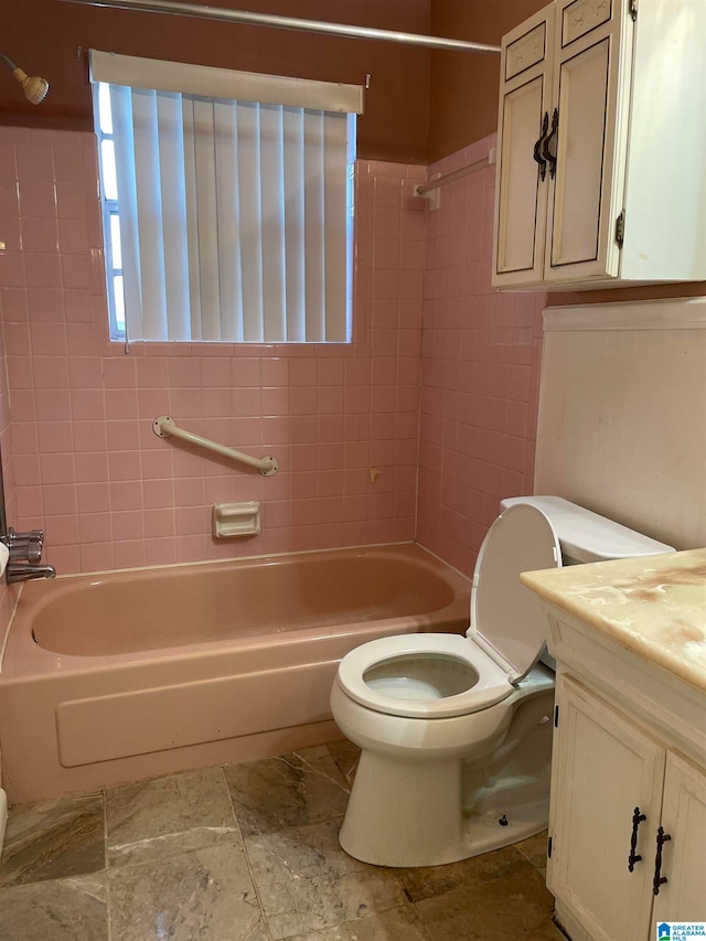 full bathroom with vanity, toilet, and tiled shower / bath combo