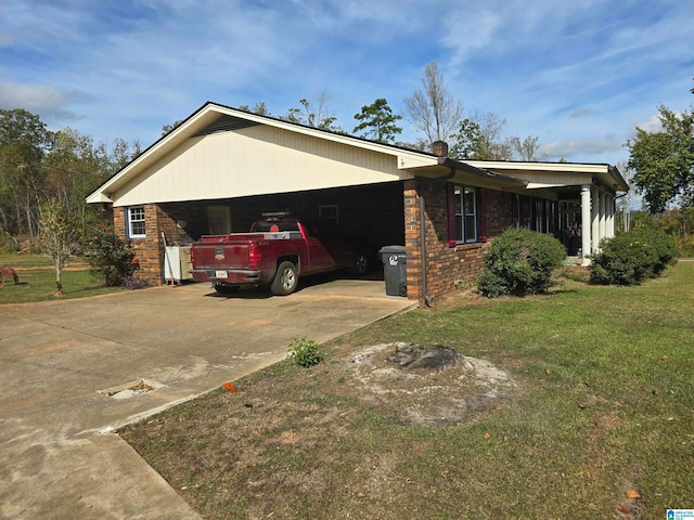 view of front of property with a front yard and a carport