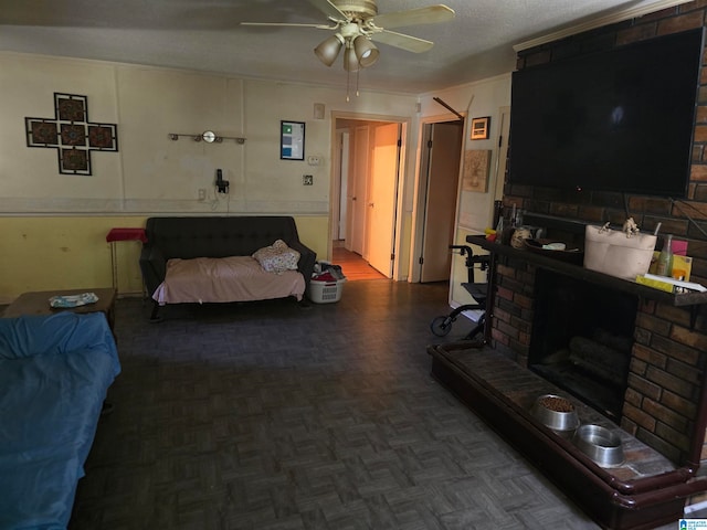 living room featuring ceiling fan, a brick fireplace, and dark parquet flooring