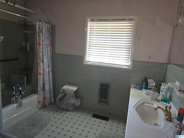 bathroom featuring vanity, shower / bathtub combination with curtain, and tile walls