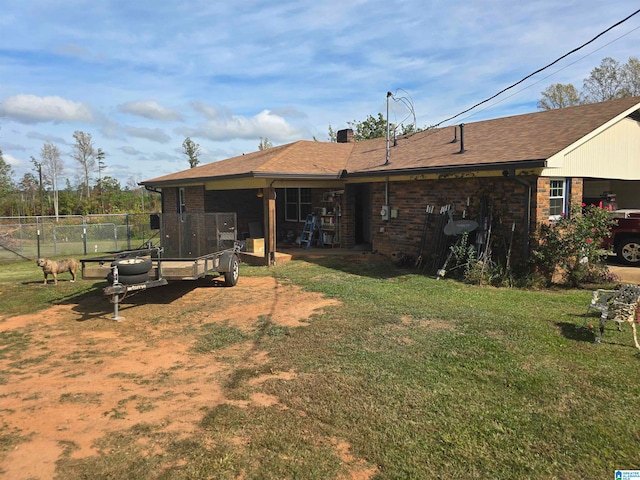 rear view of house featuring a lawn