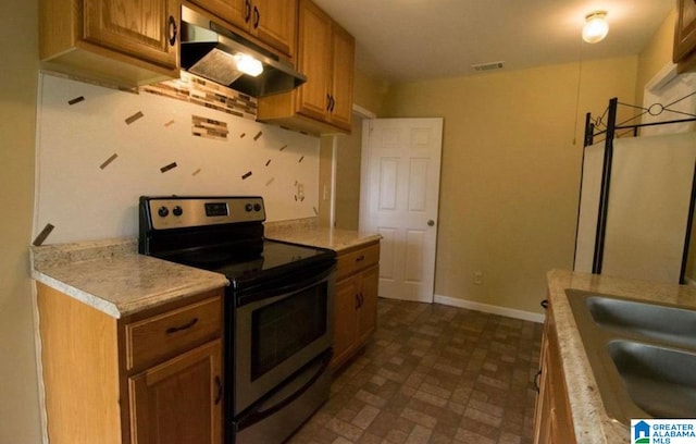 kitchen featuring stainless steel range with electric stovetop and sink