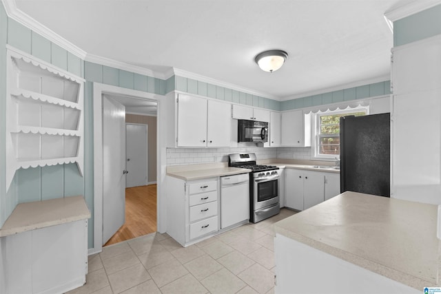 kitchen with decorative backsplash, ornamental molding, black appliances, light wood-type flooring, and white cabinets