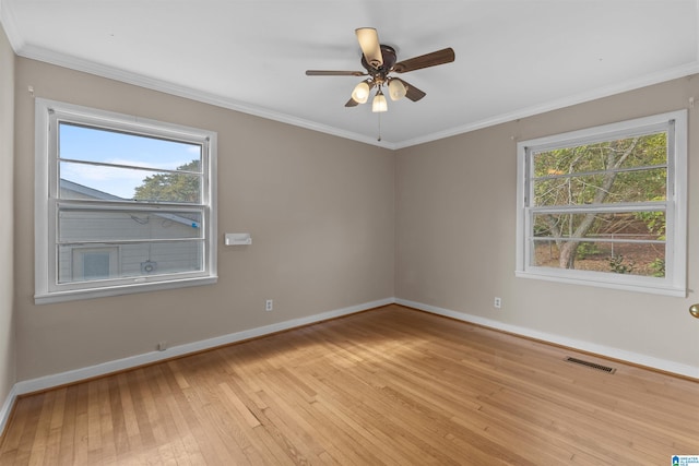 unfurnished room with crown molding, light hardwood / wood-style floors, a healthy amount of sunlight, and ceiling fan