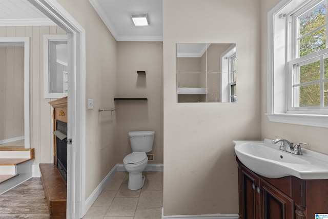 bathroom with vanity, crown molding, toilet, and tile patterned floors