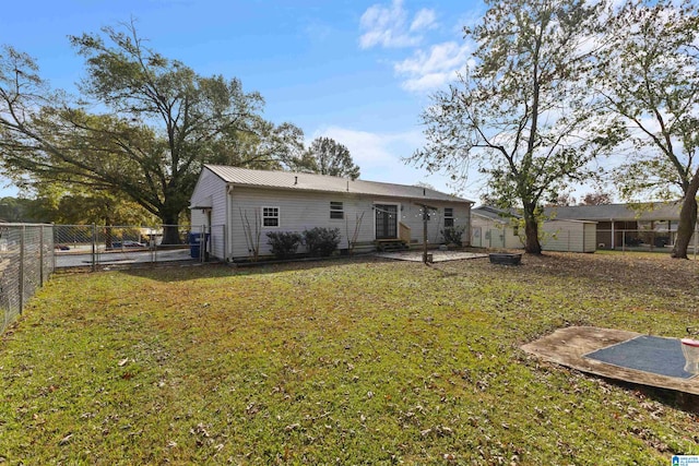 rear view of property with a yard