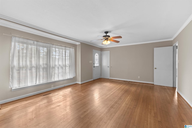 empty room featuring light hardwood / wood-style flooring, ceiling fan, and crown molding