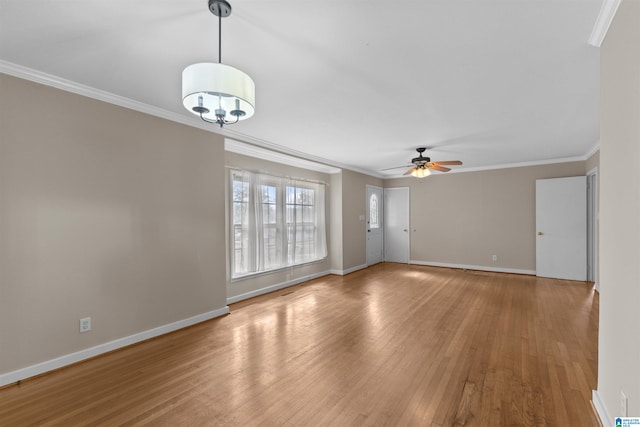 unfurnished living room featuring ornamental molding, light wood-type flooring, and ceiling fan