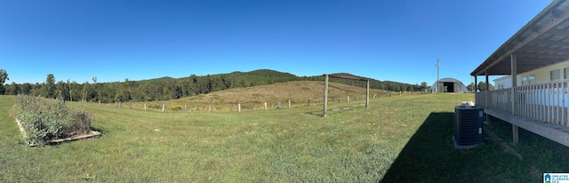 view of yard with a mountain view, a storage shed, and a rural view