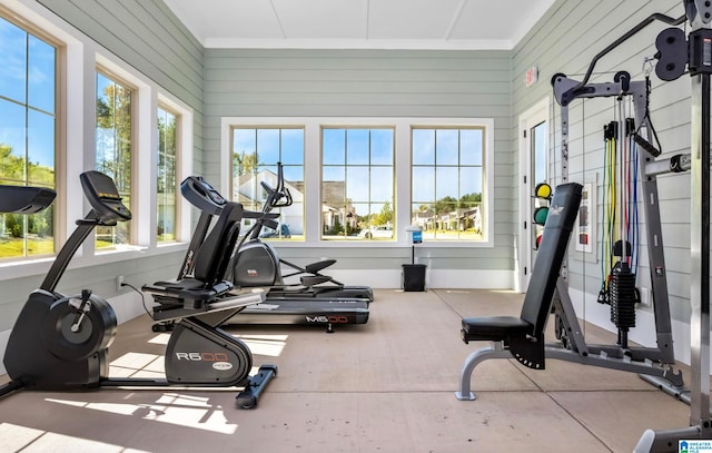 workout room featuring wood walls