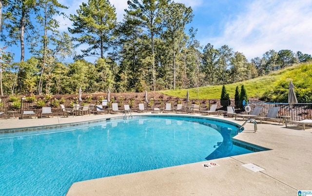 view of swimming pool featuring a patio area